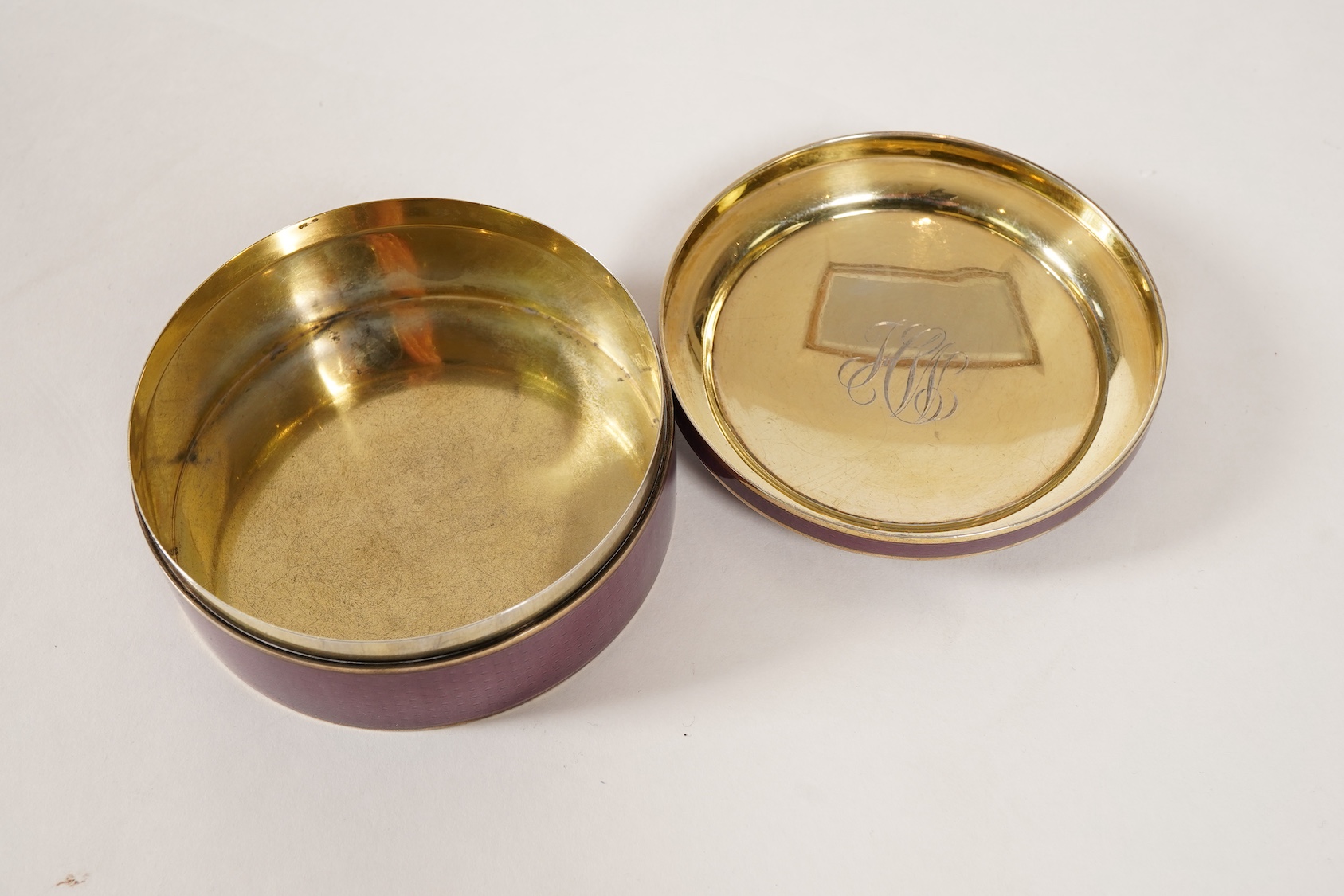 A late 19th/early 20th century North American sterling and mauve guilloche enamel circular box and cover, by Theodore B. Starr Inc, New York